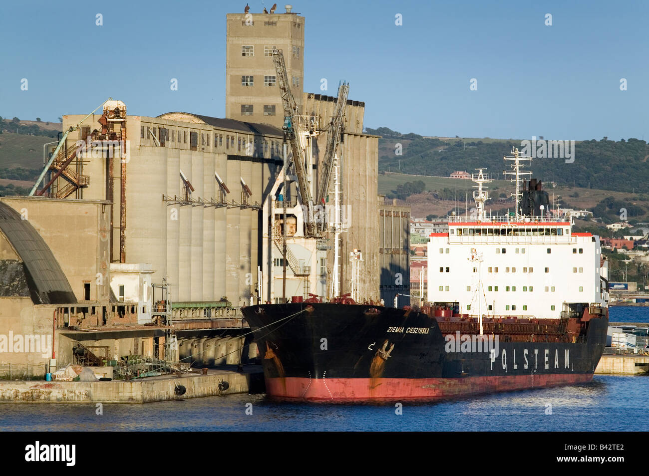 Grain silos and cargo ship at Port of Civitavecchia, Italy, the Port of Rome Stock Photo