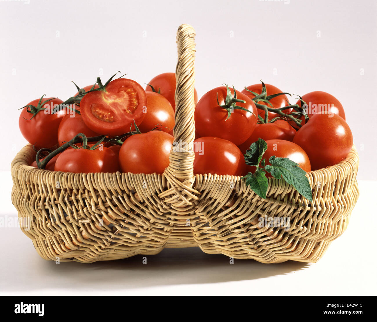 Tomatoes in basket Stock Photo - Alamy