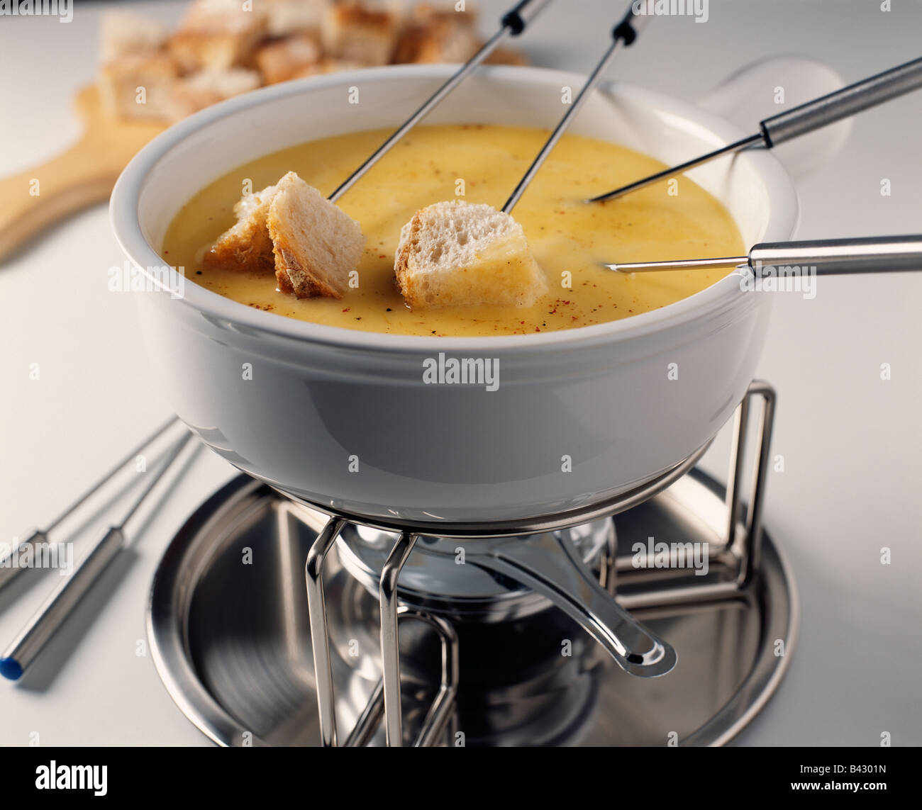 Diping the bread into the Fondue Stock Photo Alamy