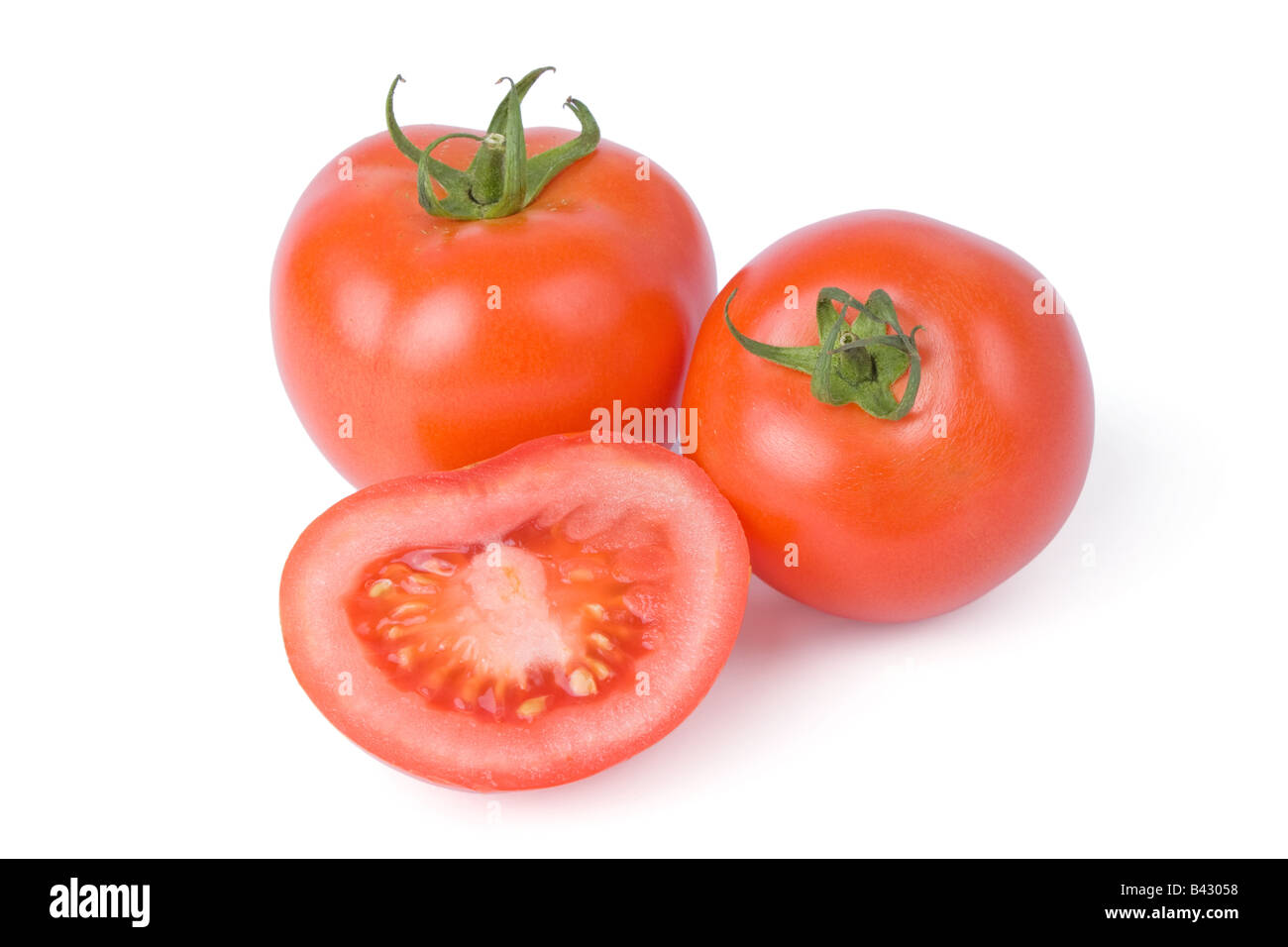 Ripe tomatoes isolated on a white background with one cut in half Stock ...