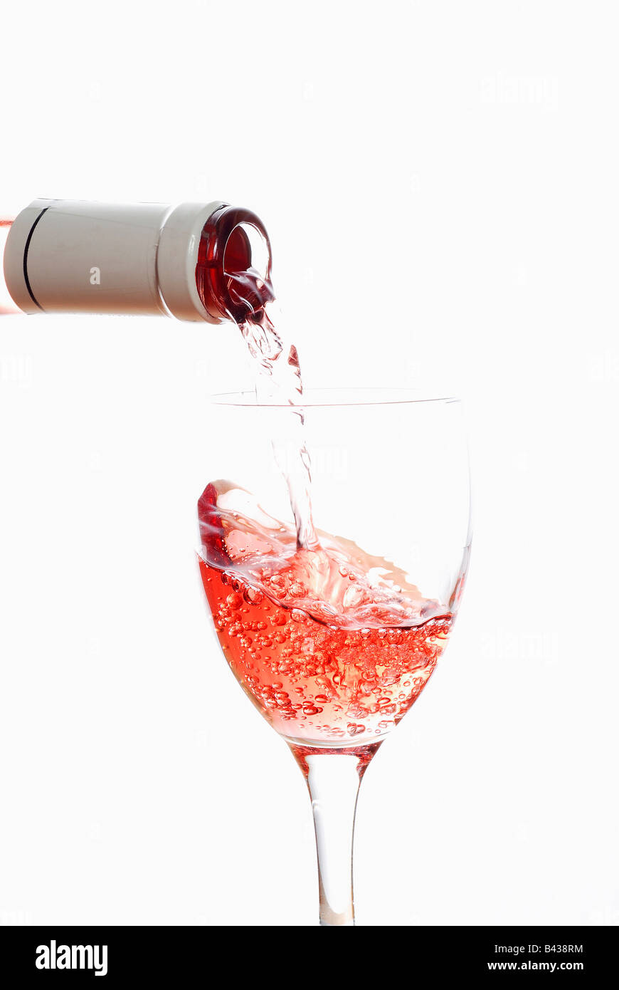 pouring rosé wine into a glass Stock Photo - Alamy