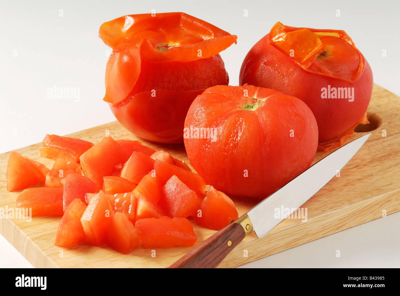 Taking the skin off the tomatoes Stock Photo Alamy