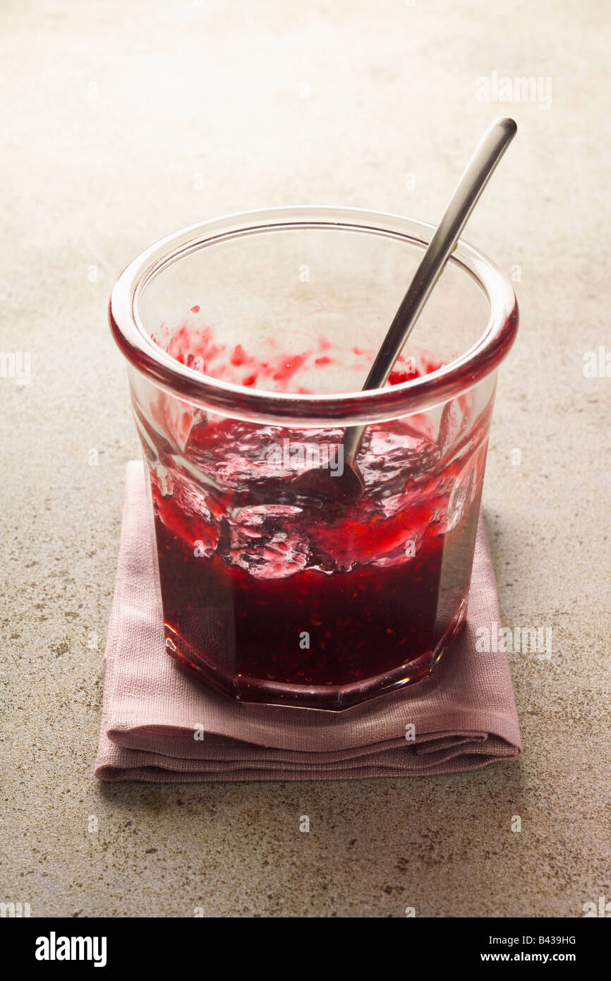 Started pot of raspberry jam Stock Photo - Alamy