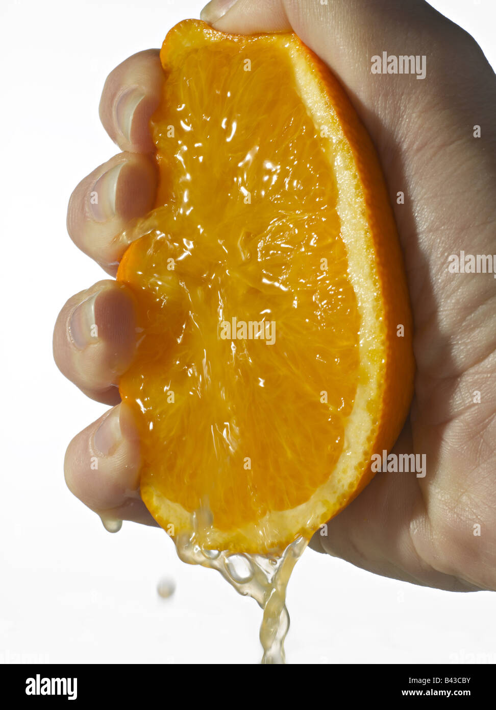 Hand squeezing an orange Stock Photo Alamy