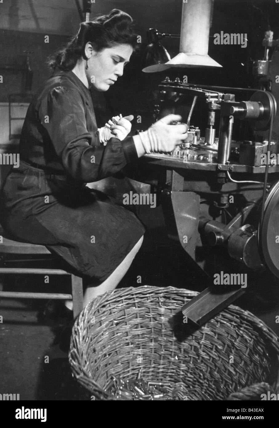 events, Second World War / WWII, Germany, armaments industry, production of ammunition, woman at machine, Berlin, 1942, propagada photo, Stock Photo