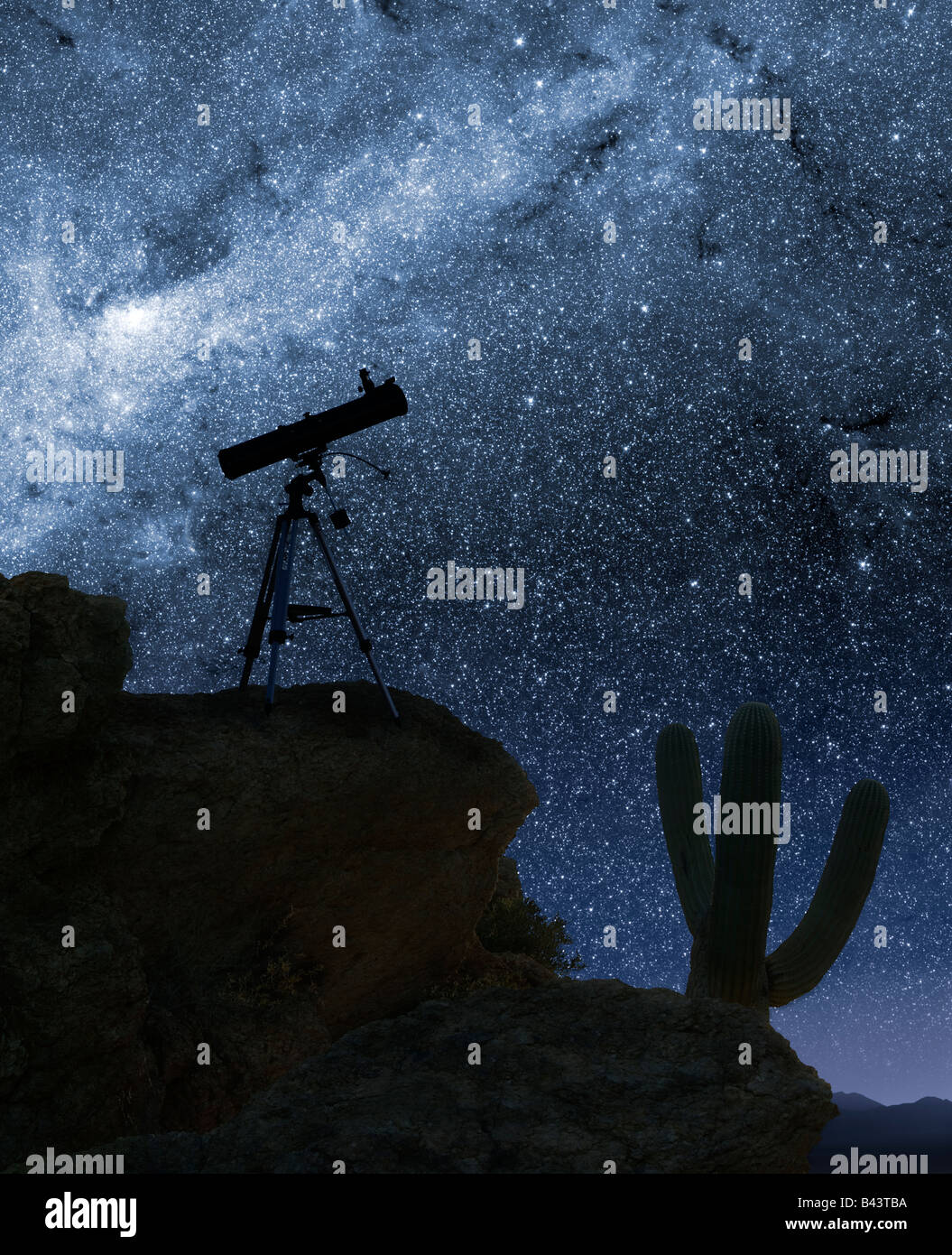 A telescope pointed at the stars from a desert mountain location Stock Photo