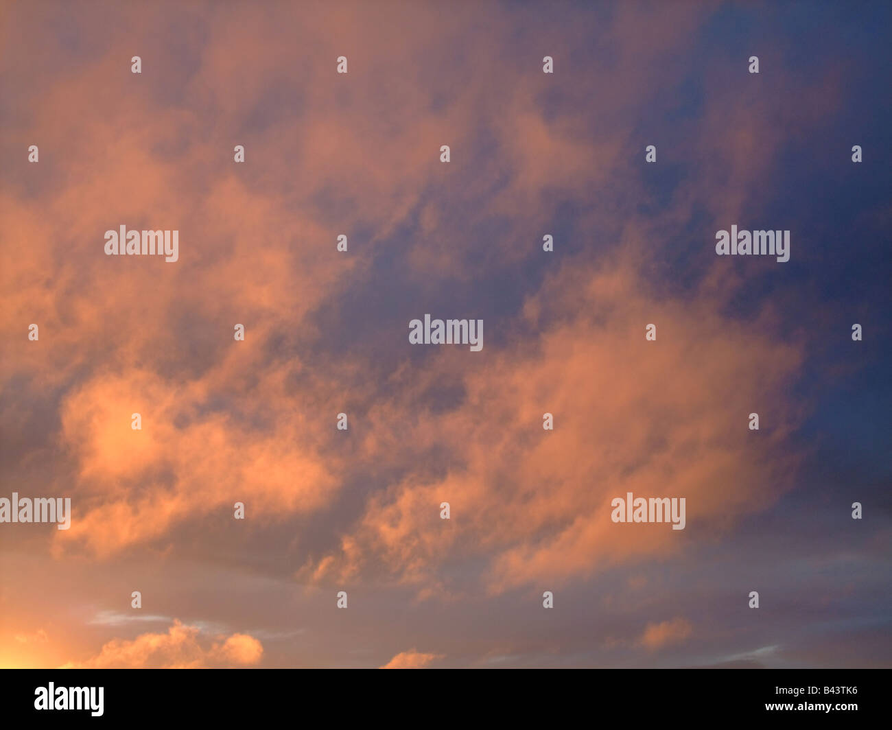 Low stratus (Sc) clouds with orange reflection on sunset Stock Photo
