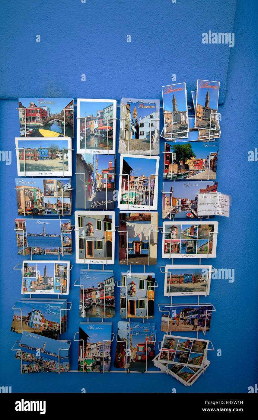Postcards of Burano displayed on a blue wall, Venice, Italy Stock Photo