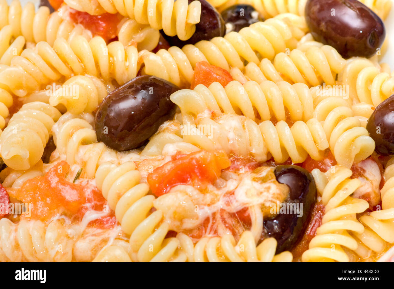 Italian Pasta with cheese fresh tomatoes and olives Stock Photo