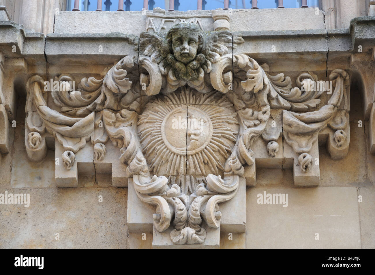 Detail of stone carved windowsill decoration with the sun and moon depicted with angels face Salamanca Spain Stock Photo