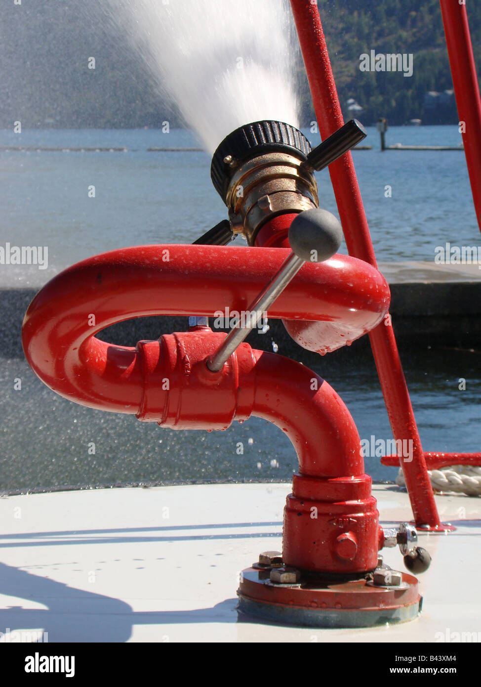 Closeup of water cannon as it blasts water from firefighter boat. Stock Photo