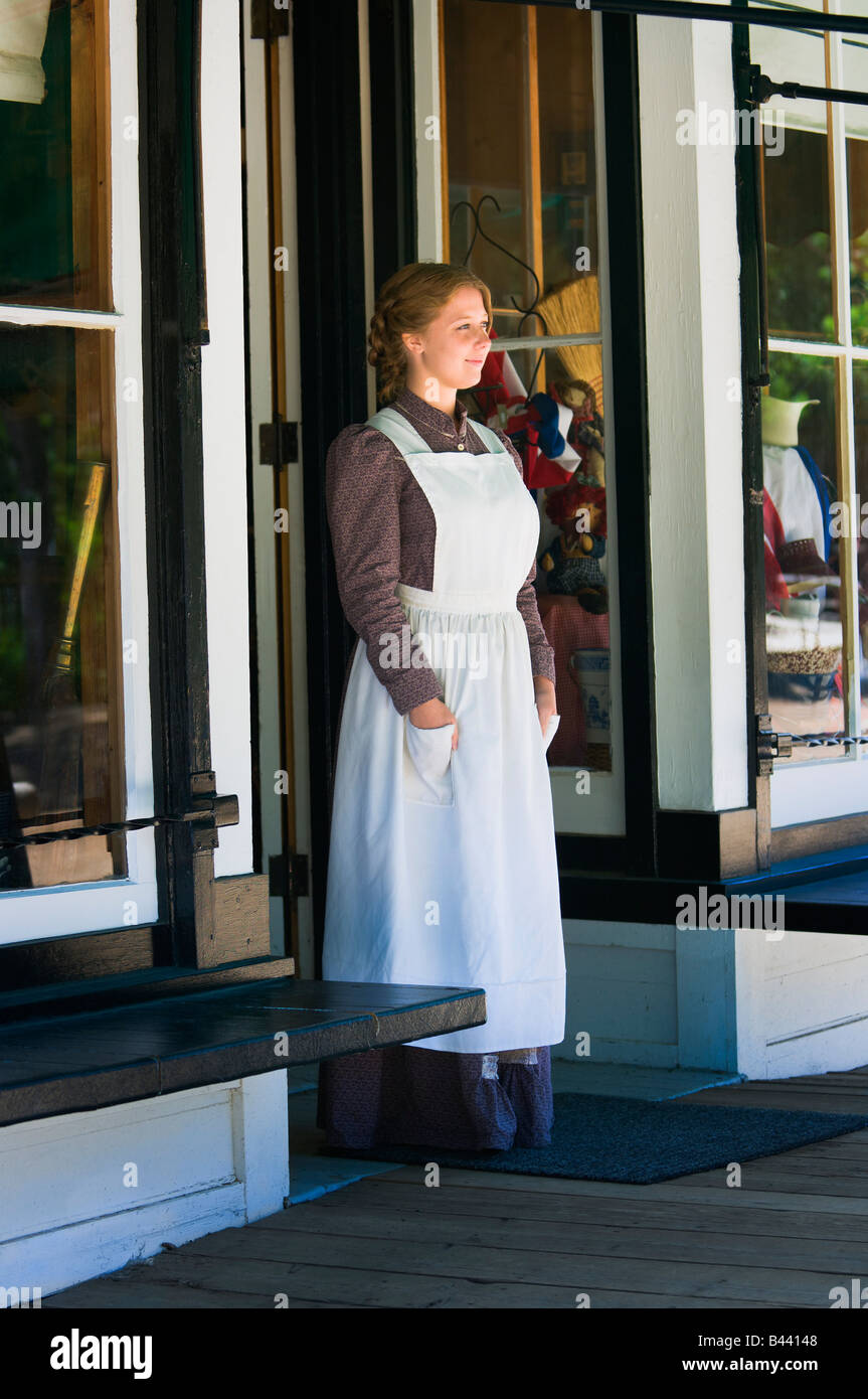 Young woman standing in store doorway Stock Photo - Alamy
