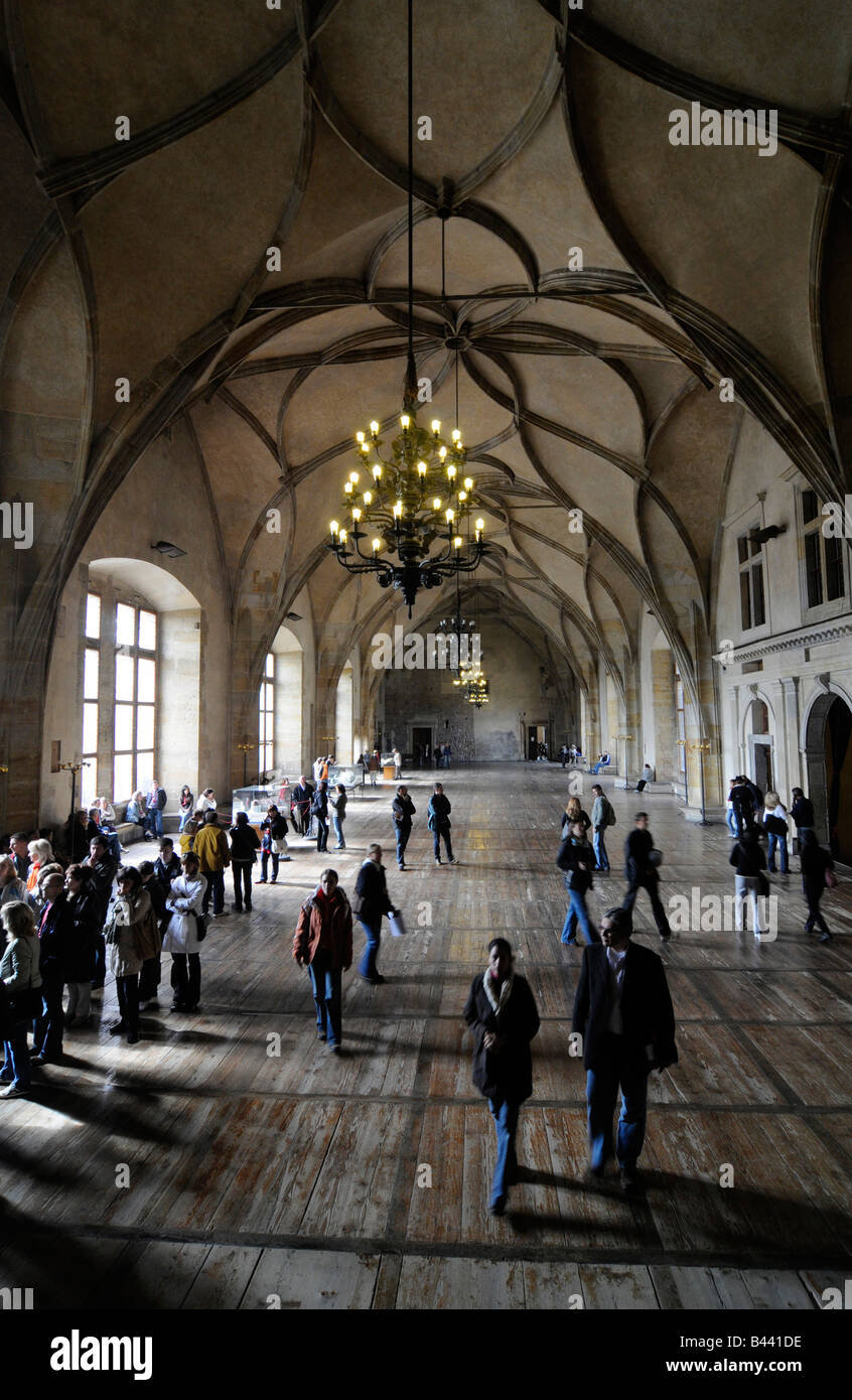 Tourists walking inside the main room of the Royal Palace in the Prague castle compound, Czech republic. Stock Photo