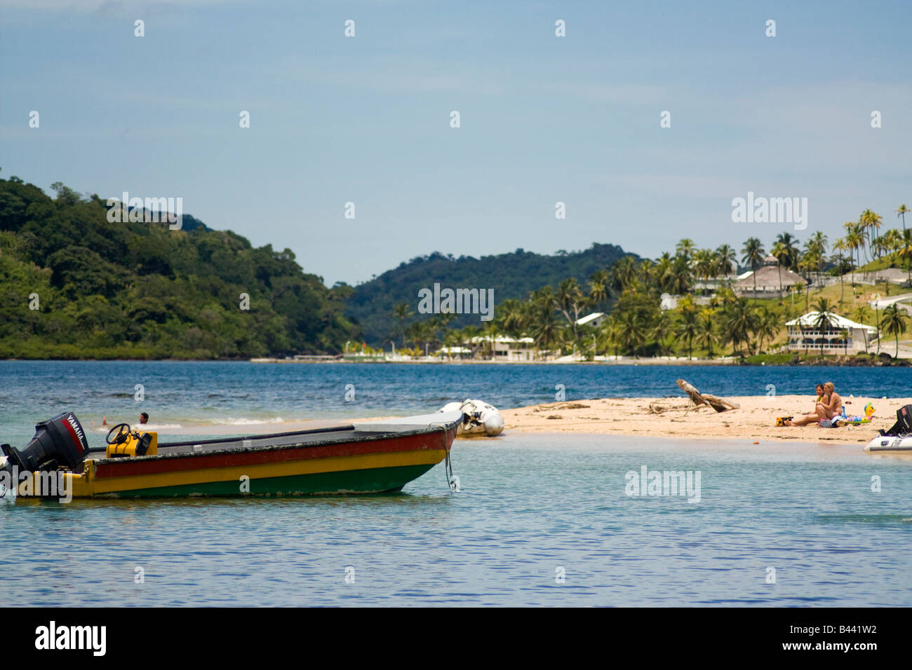 Panama, Isla Grande, Small peninsula of sand is good as natural port for a colorful boat Stock Photo