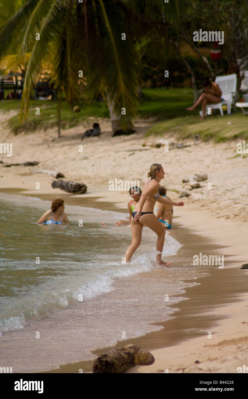 Panama Isla Grande European tourist walks leaving the beach to lean back and to take a sun bath Stock Photo