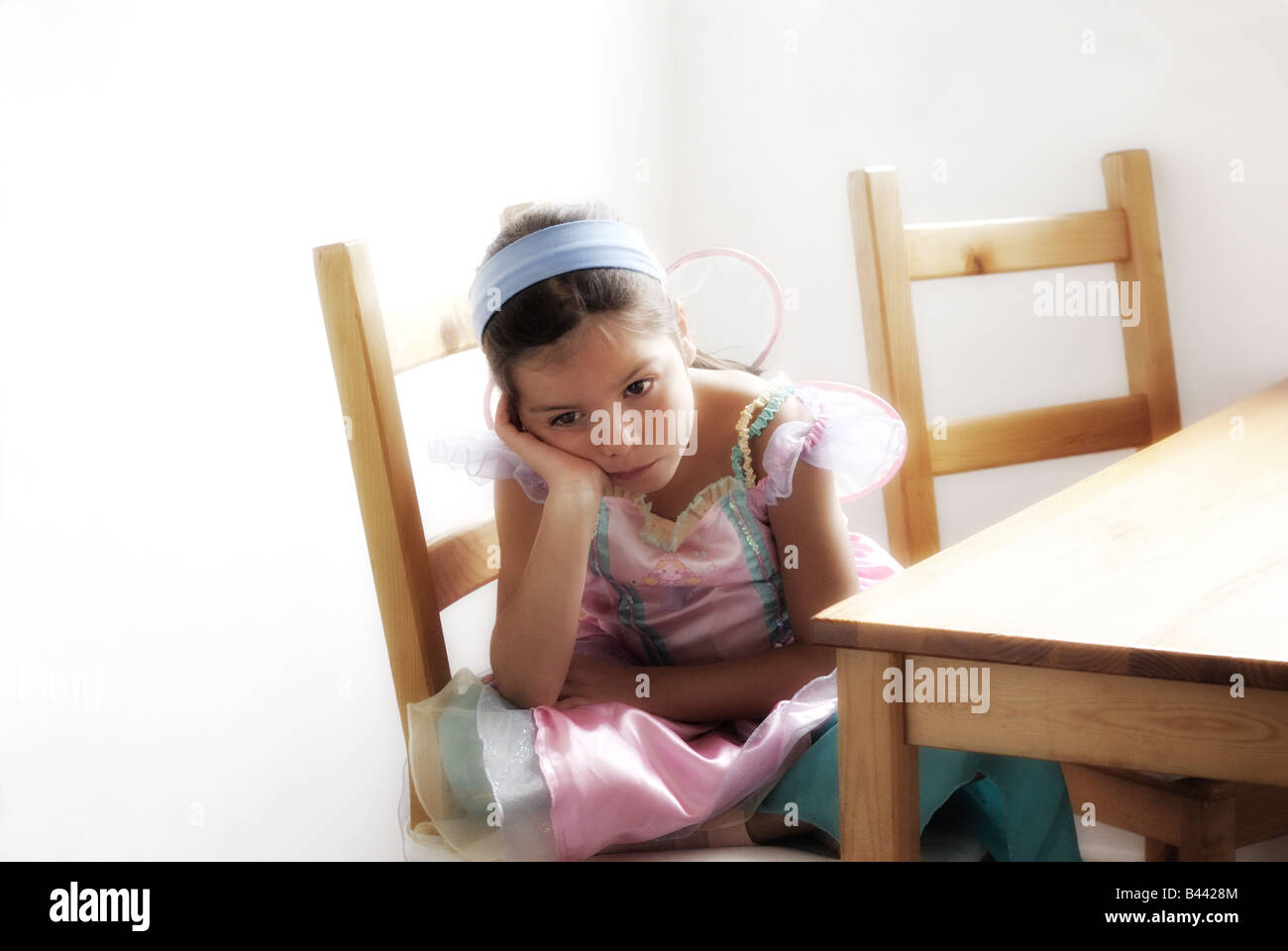 Pensive child in party dress Stock Photo