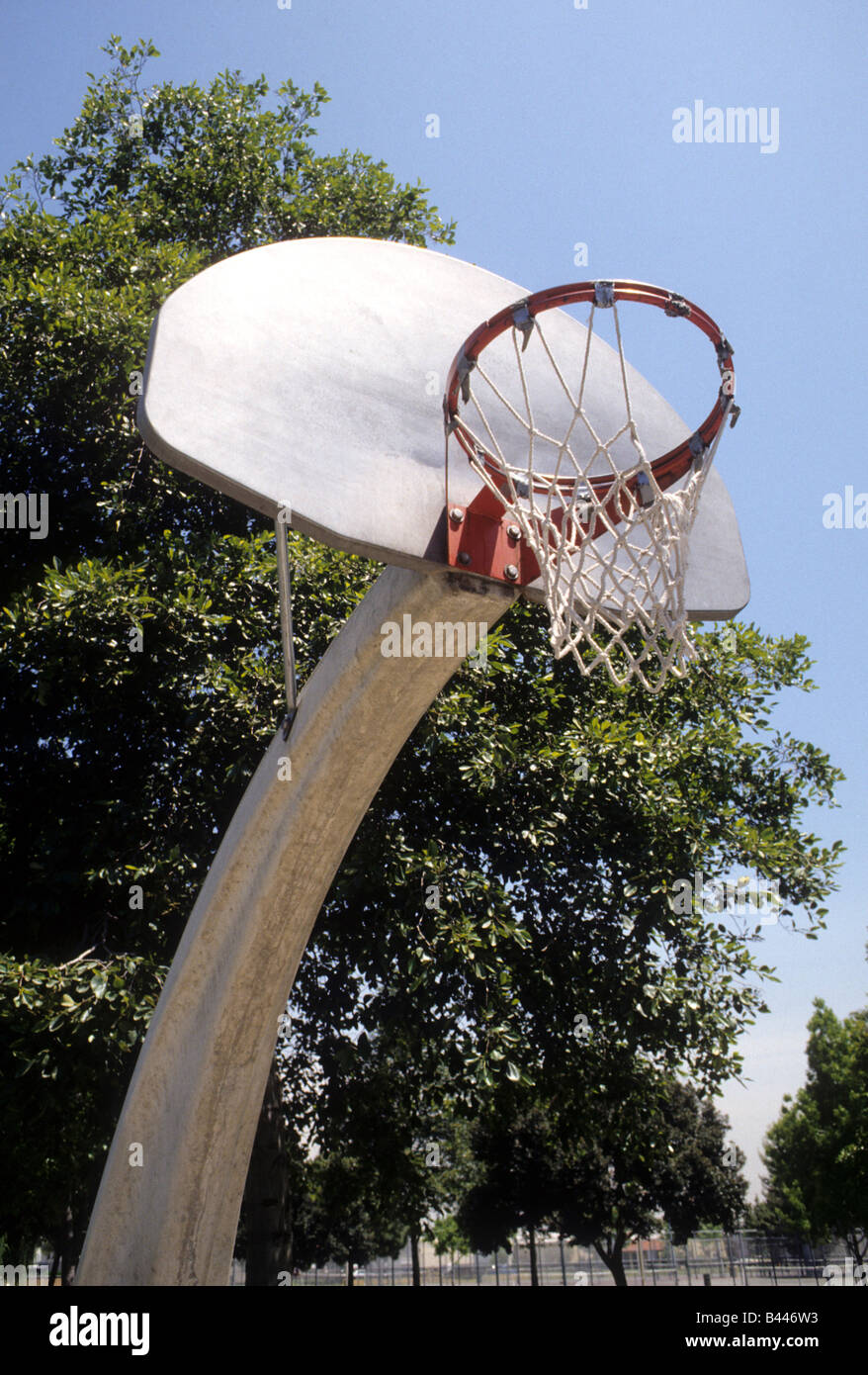 basketball backboard, rim, and net on support pole in city park. Stock Photo