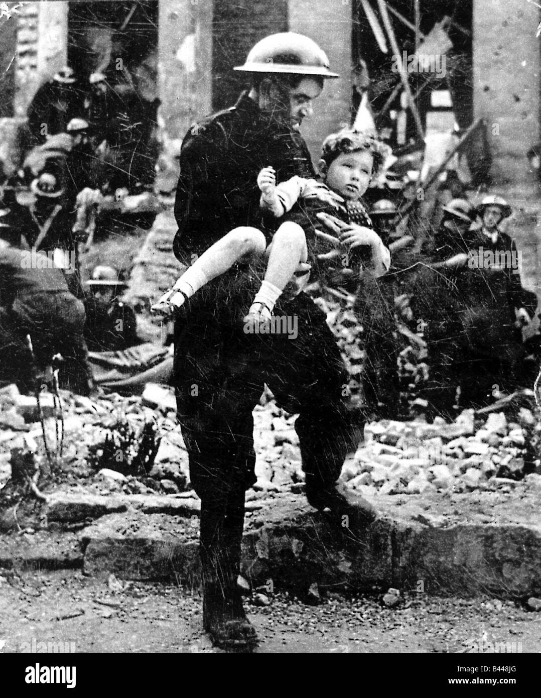 Clydebank Blitz March 1941 World War Two little girl saved from devastation in street Firemen Air raid Army bomb damage Stock Photo