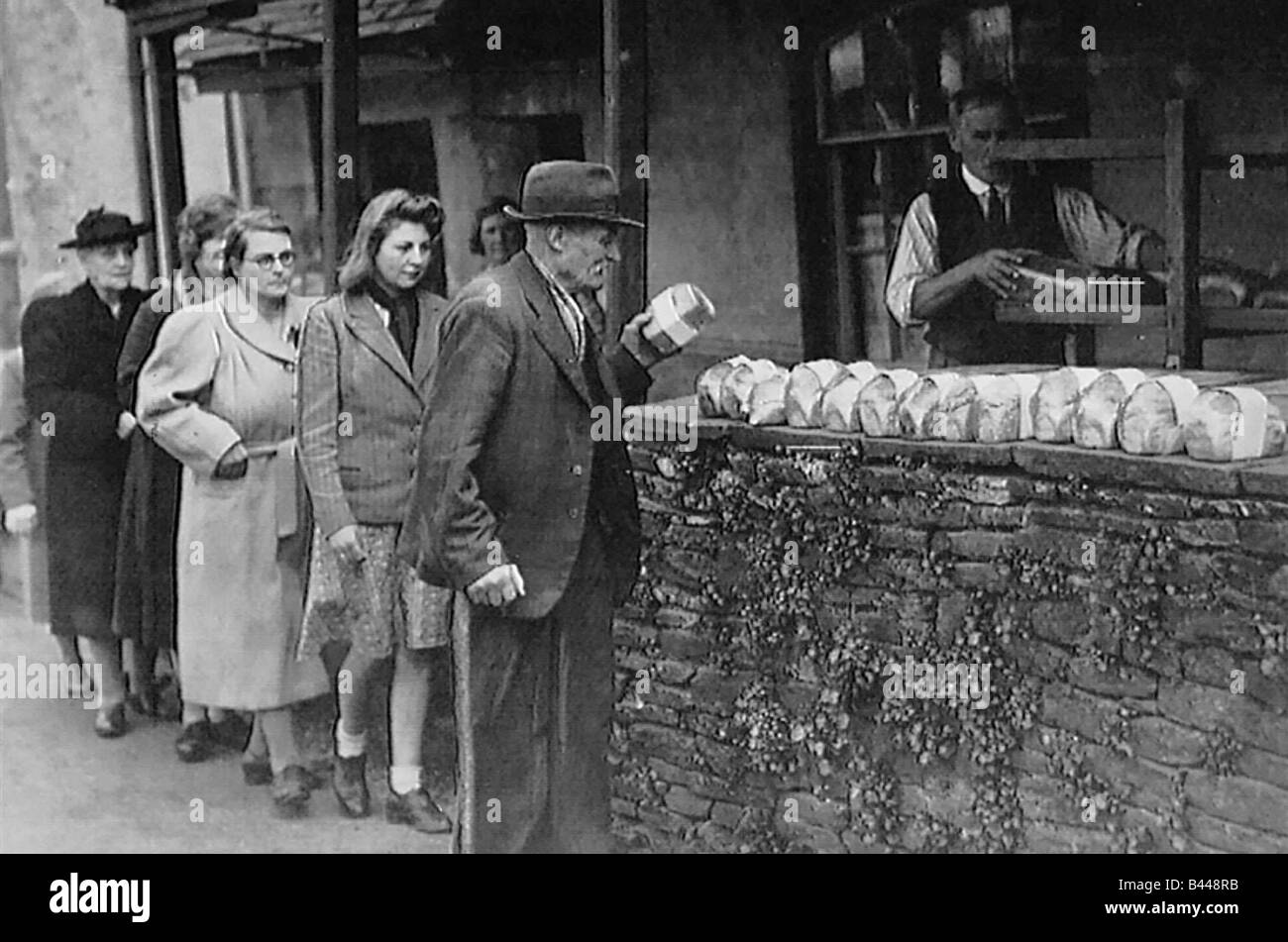 Wartime food rationing people queuing up for their shopping bread rationing Stock Photo