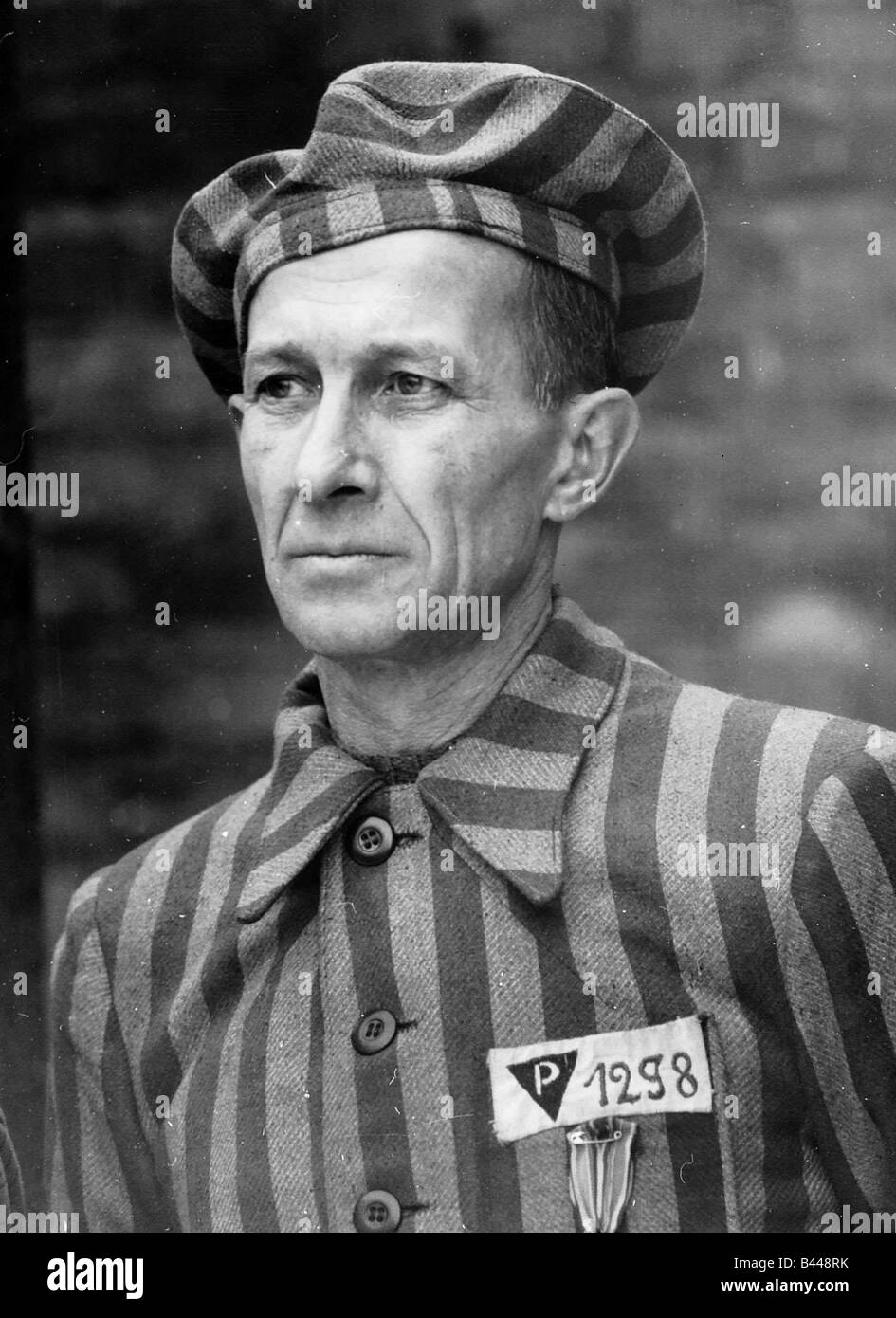 World War Two Auschwitz man wearing concentration camp prisoners uniform at ceremony of remembrance Stock Photo