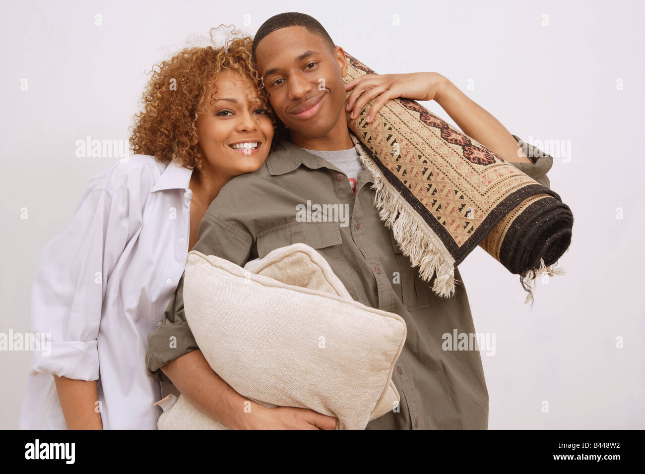 African couple carrying pillows and rug Stock Photo Alamy