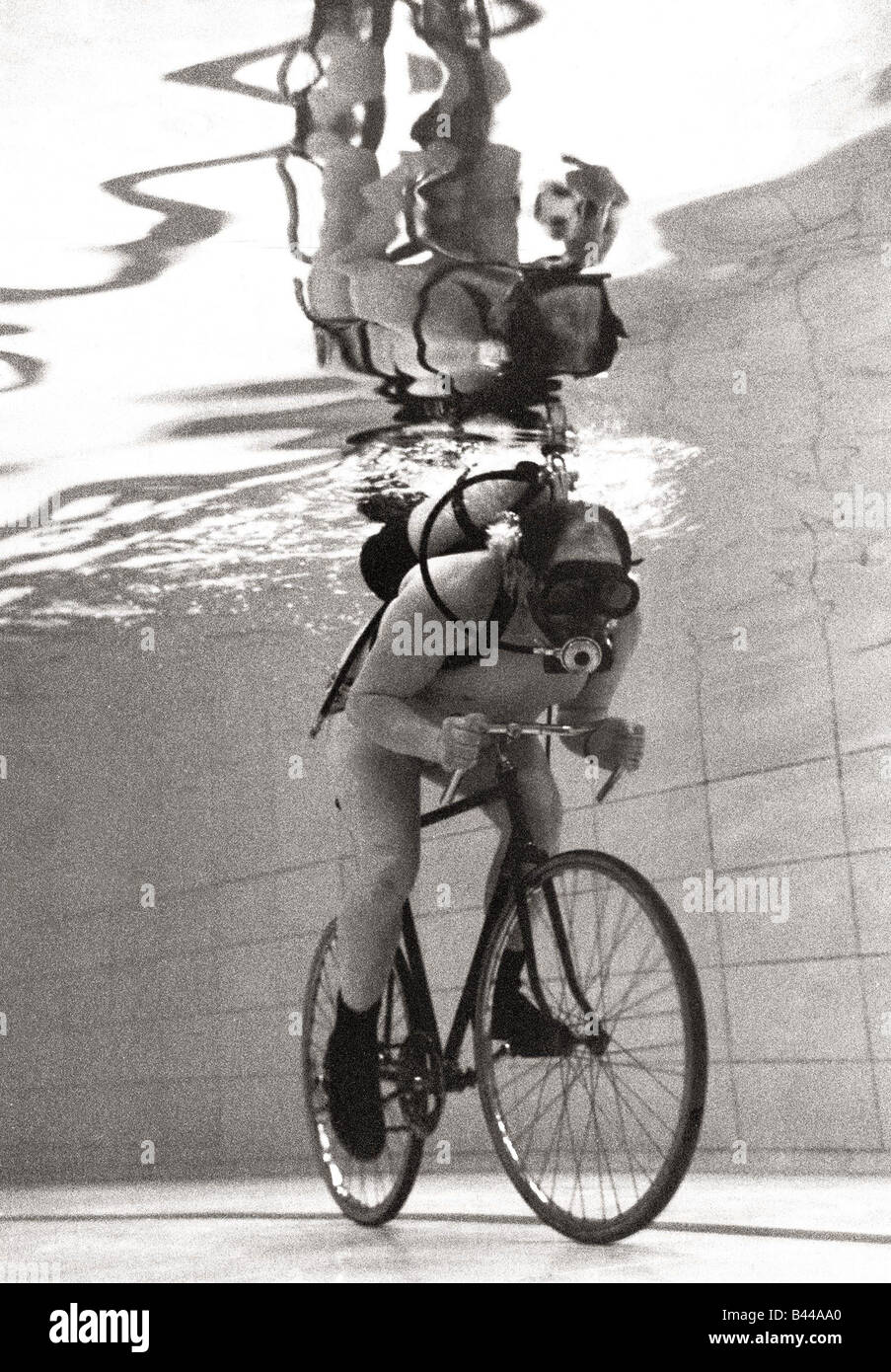 John Camm rides bicycle underwater at his local swimming pool with the