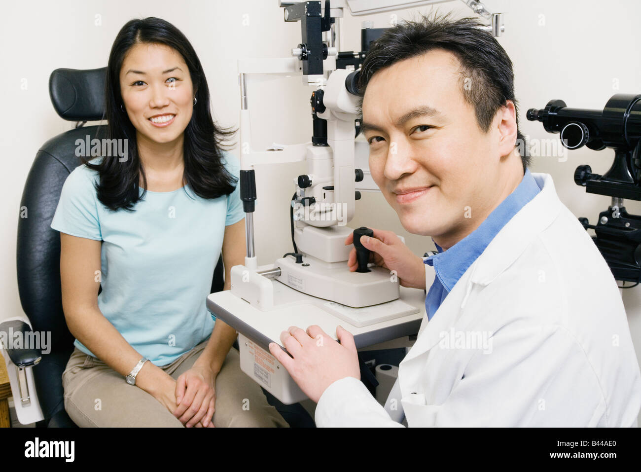 Asian male optometrist examining patient Stock Photo Alamy