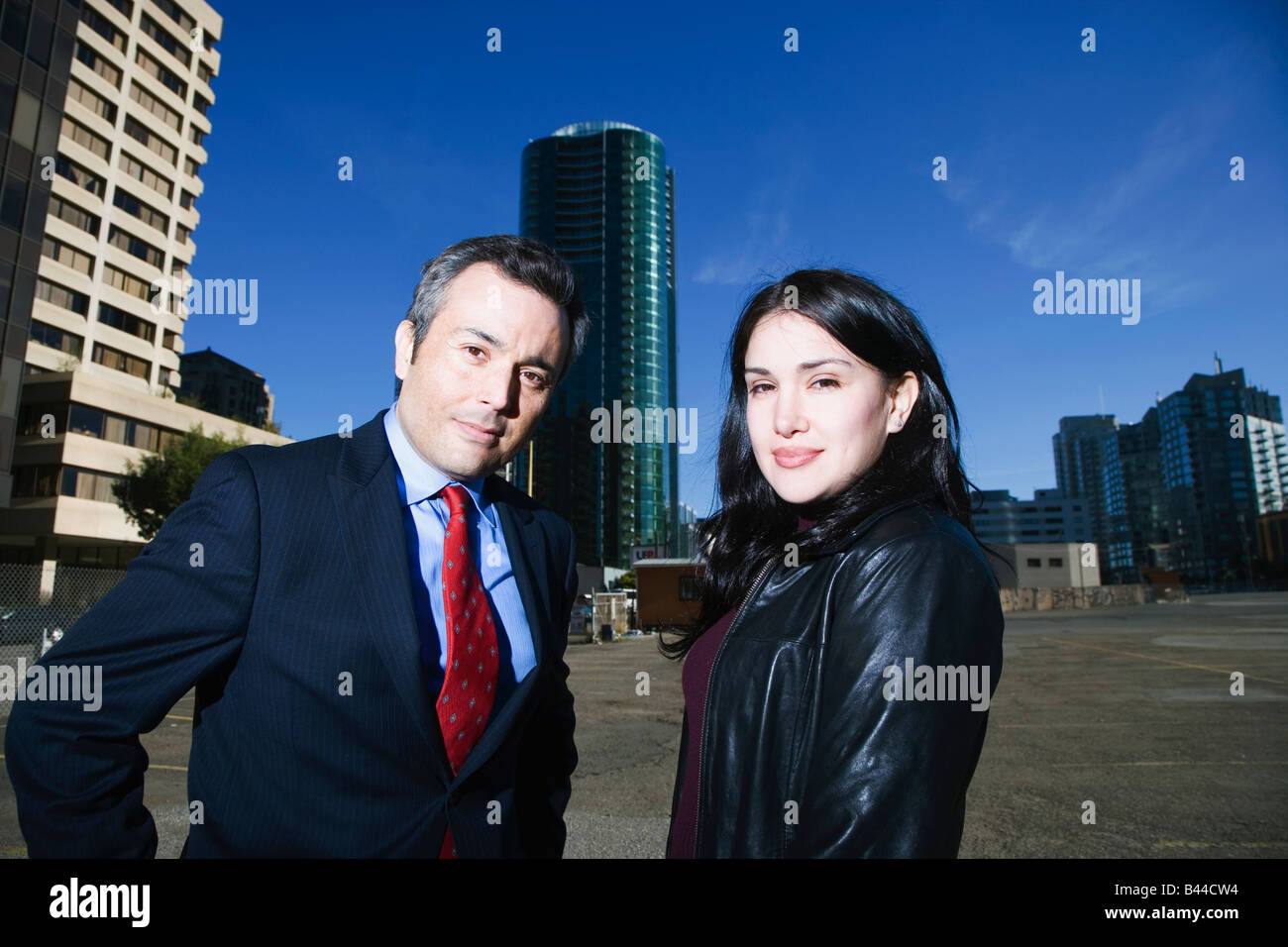 Hispanic businesspeople in front of high-rises Stock Photo