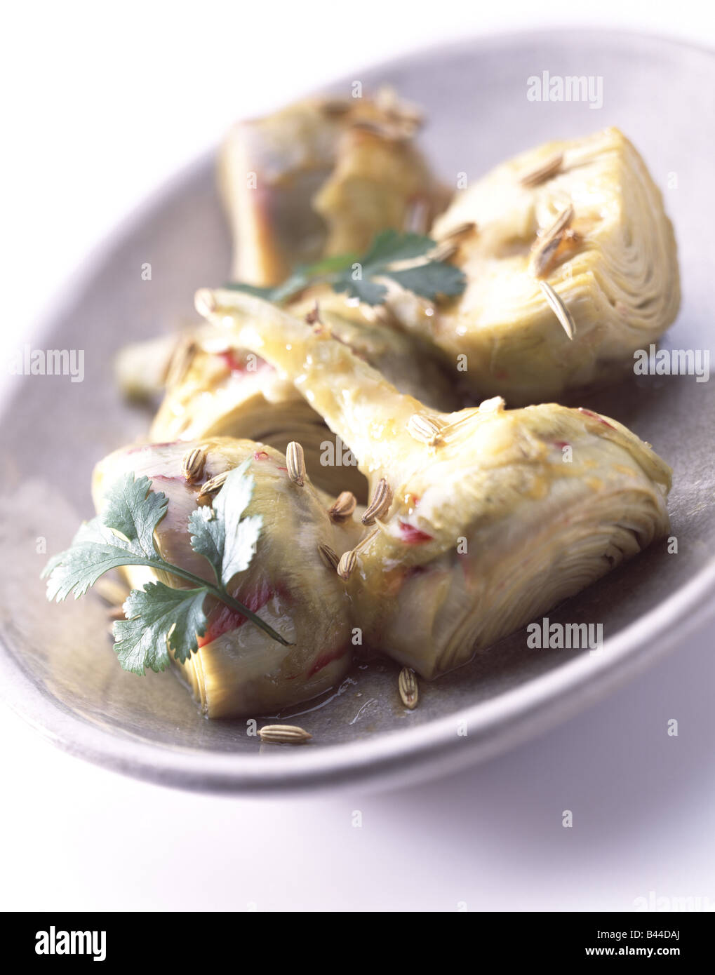 marinated artichoke hearts with coriander Stock Photo Alamy