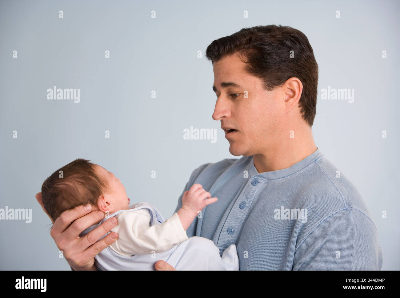 Hispanic father holding baby Stock Photo