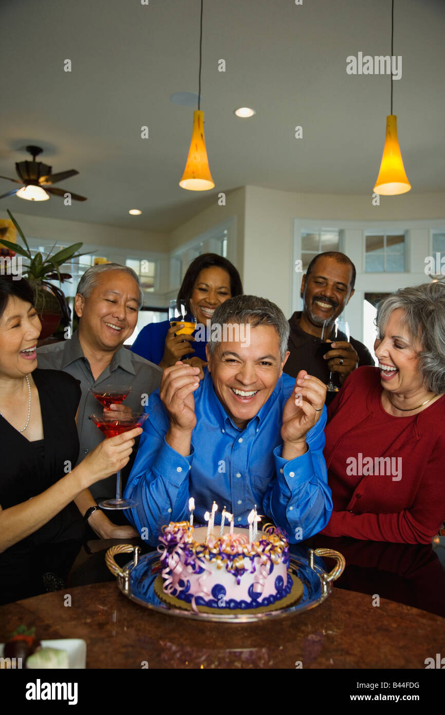 Hispanic man celebrating birthday with multi-ethnic friends Stock Photo
