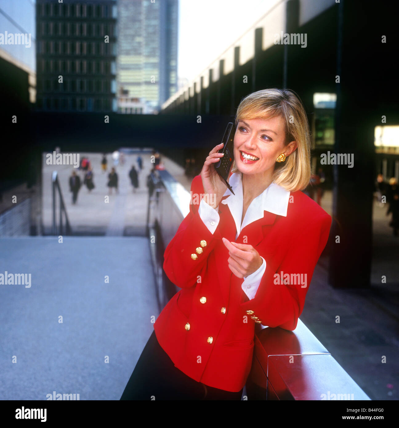 1980's  MODEL FASHION MOBILE FLIP PHONE 1st generation flip mobile cell telephone Motorola advert photo fashion city image executive businesswoman UK Stock Photo