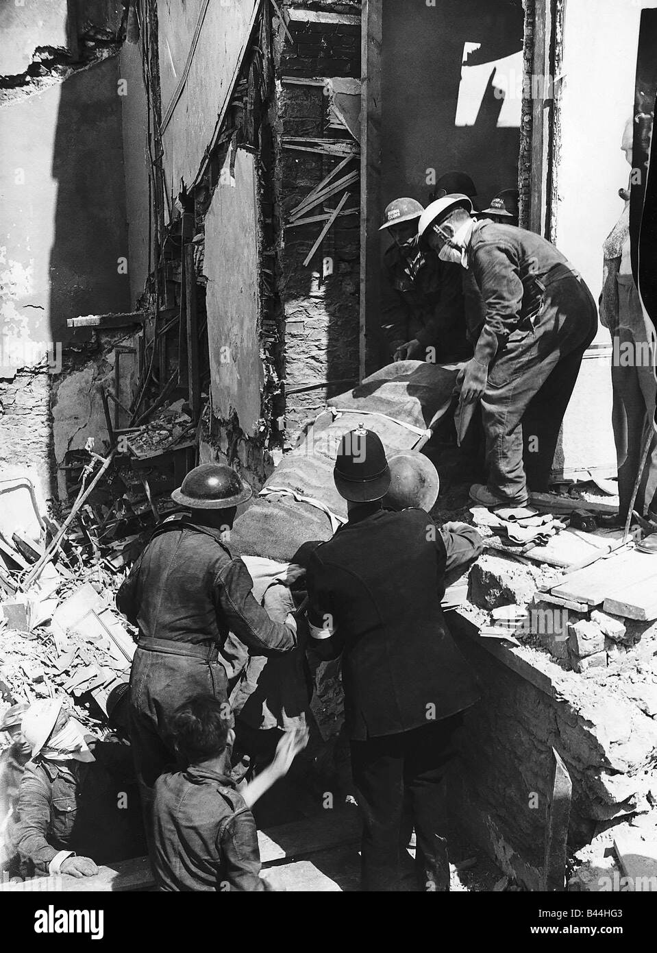 Rescue workers remove a body from a bombed building in Plymouth Devon after a WW2 air raid 1944