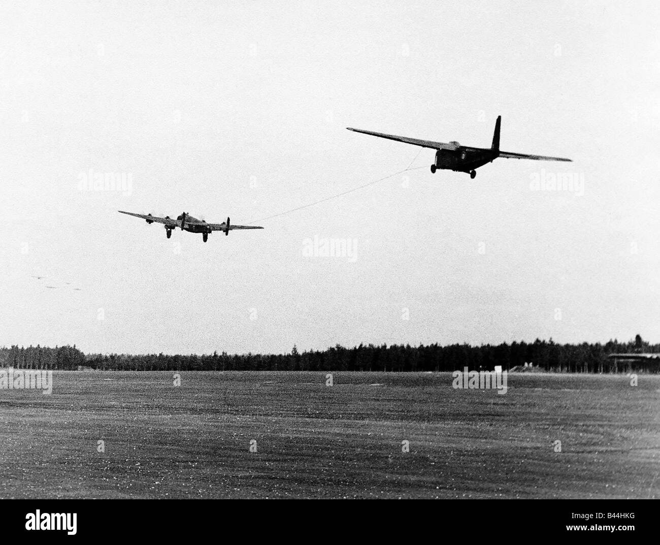 Halifax bomber towing a glider takes off from English airfield as part