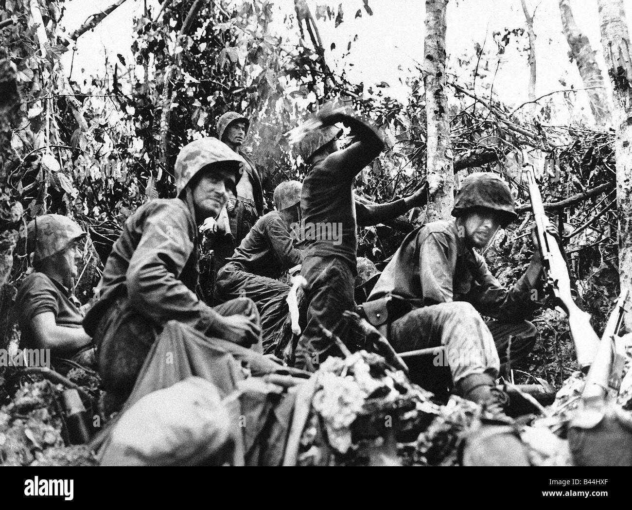 US marine about to throw a handgrenade at the enemy as his unit fights its way across a Pacific Island WW2 October 1944 1940s Stock Photo