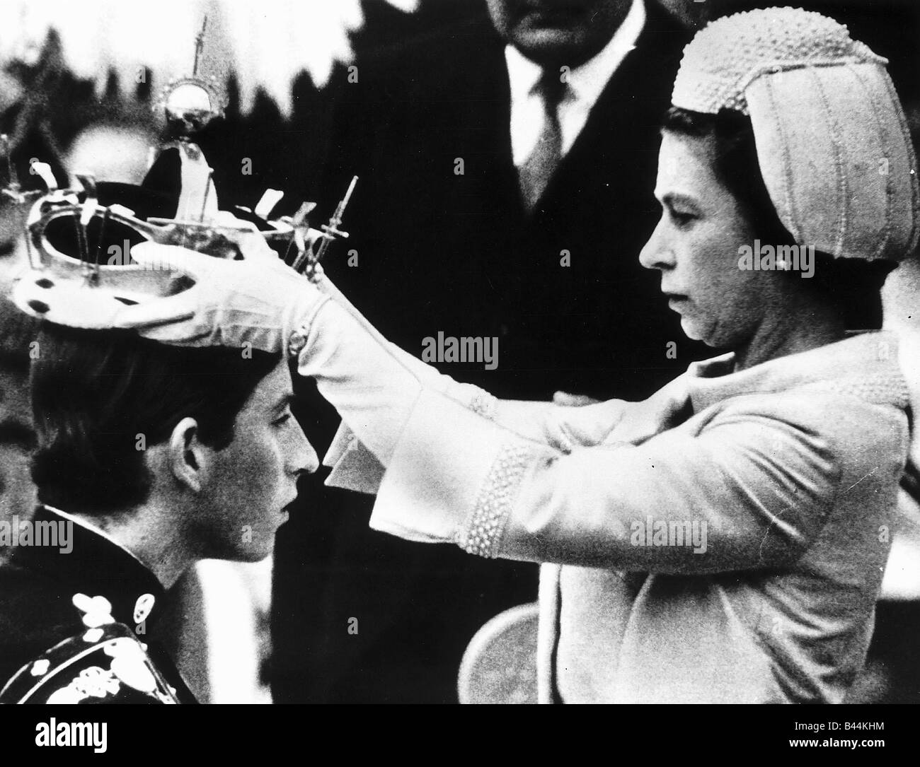 HRH Queen Elizabeth II places crown on the head of Prince Charles in