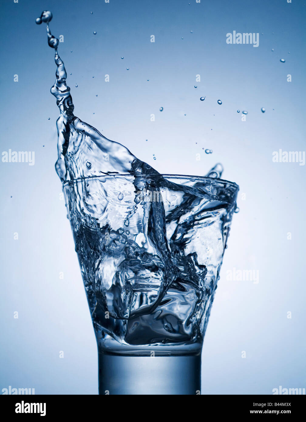 ice cube falling into glass of water Stock Photo - Alamy