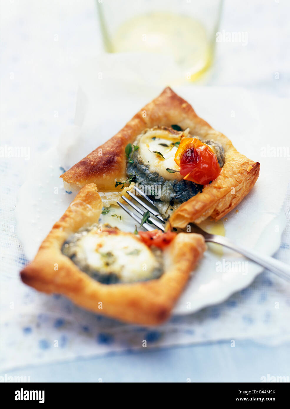 Goat's cheese and tomato puff pastry tartlets Stock Photo Alamy