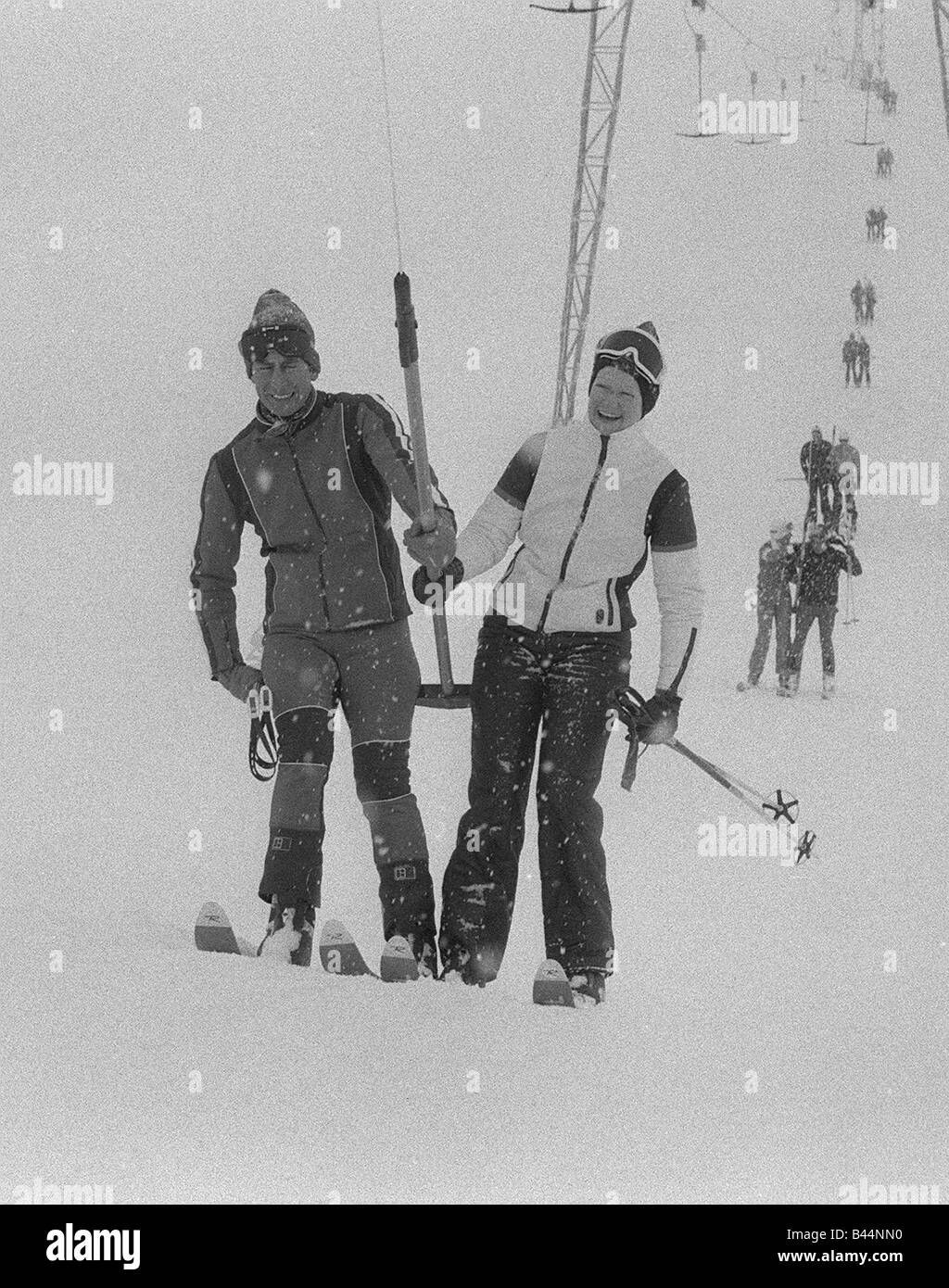 Prince Charles with Lady Sarah Spencer sharing a ski lift chair in Switzerland Wearing goggles and ski suit Stock Photo