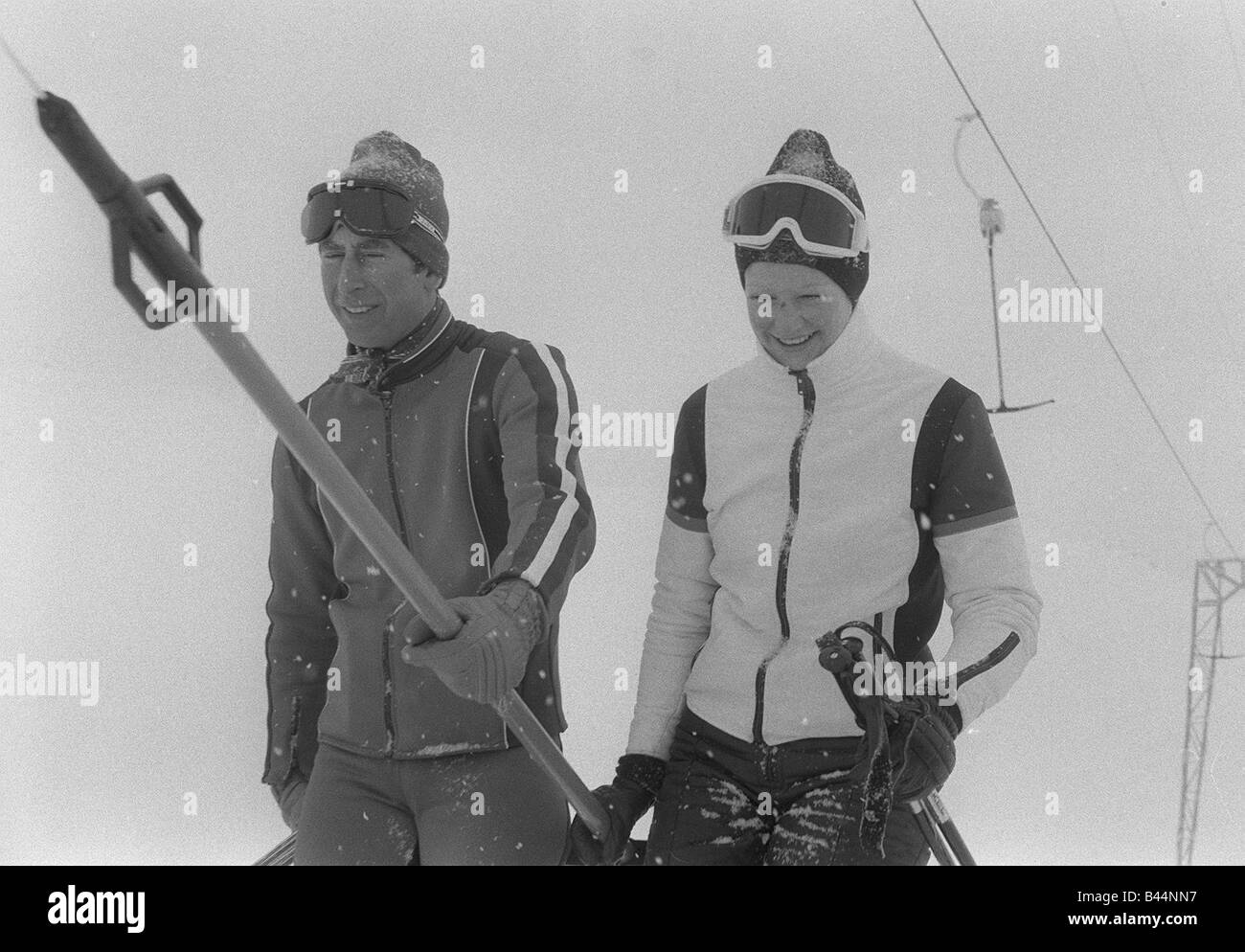 Prince Charles with Lady Sarah Spencer sharing a ski lift chair in Switzerland Wearing goggles and ski suit in 1970s Stock Photo