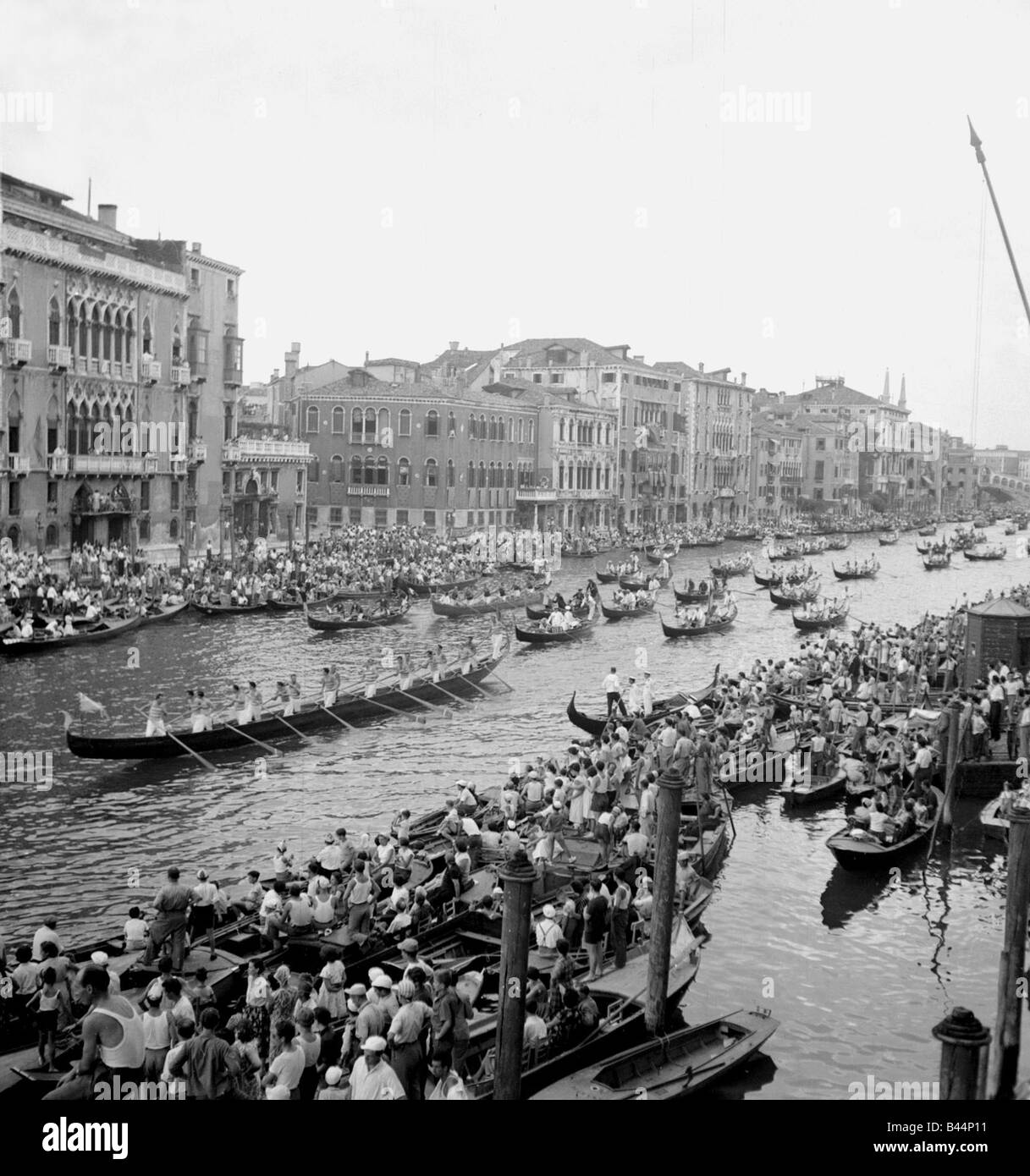 A procession of the gondolas pass along the Grand Canal after the race of the nine gondolas at the annual historic Regatta Stock Photo