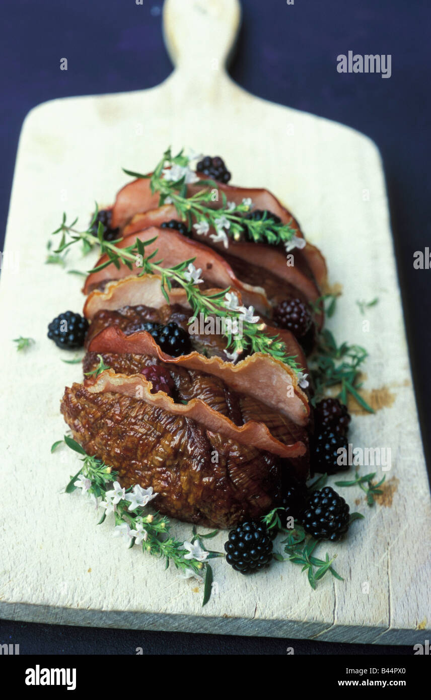 Roast beef with bacon,thyme in flower and blackberries Stock Photo Alamy
