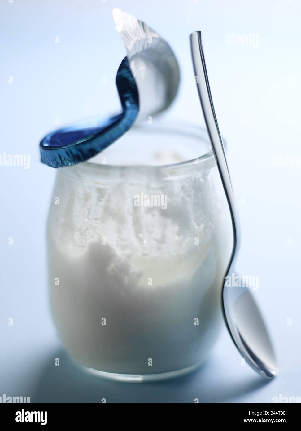 Open and started pot of yoghurt Stock Photo Alamy