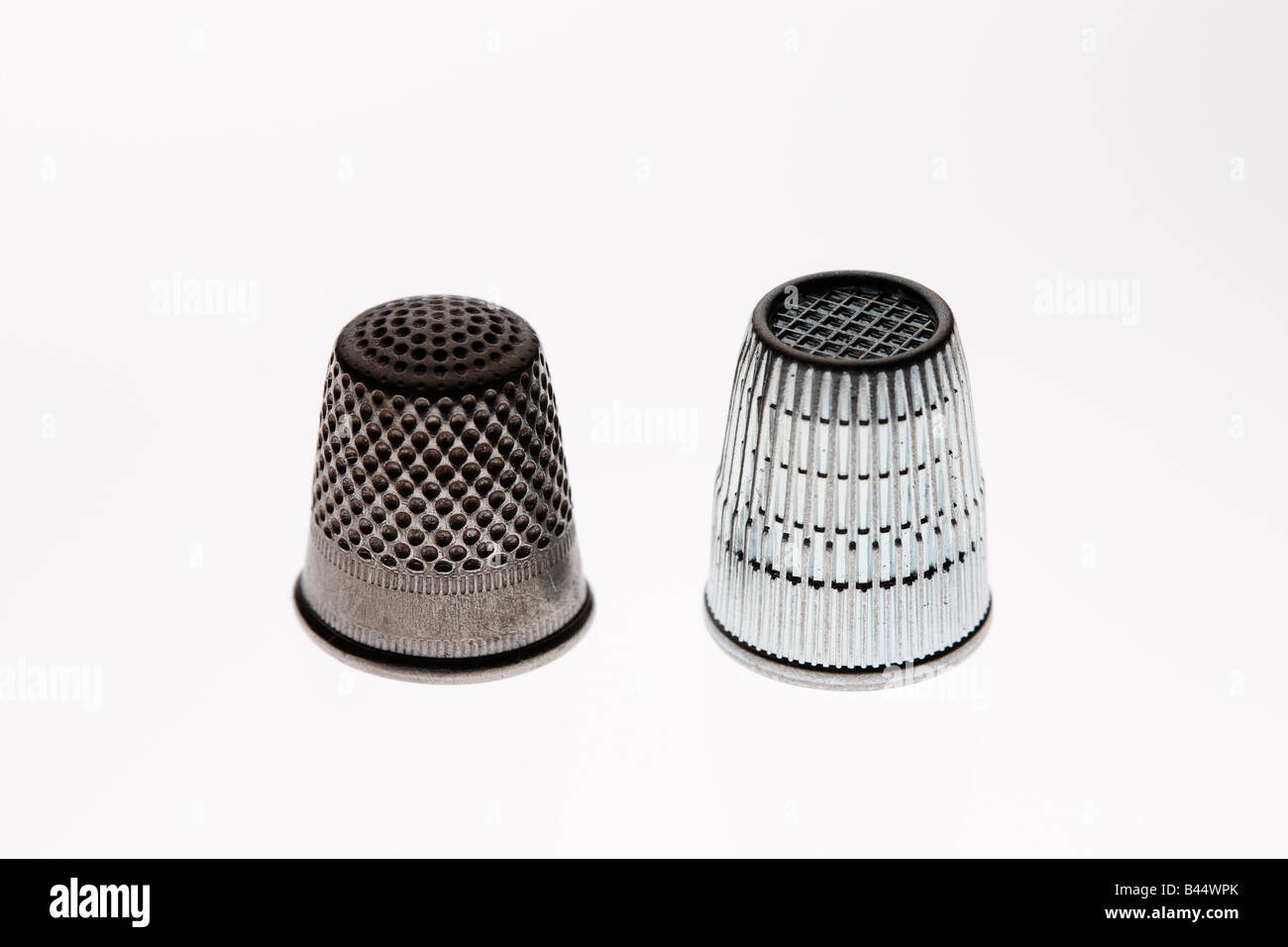 Old and new thimble side by side Stock Photo