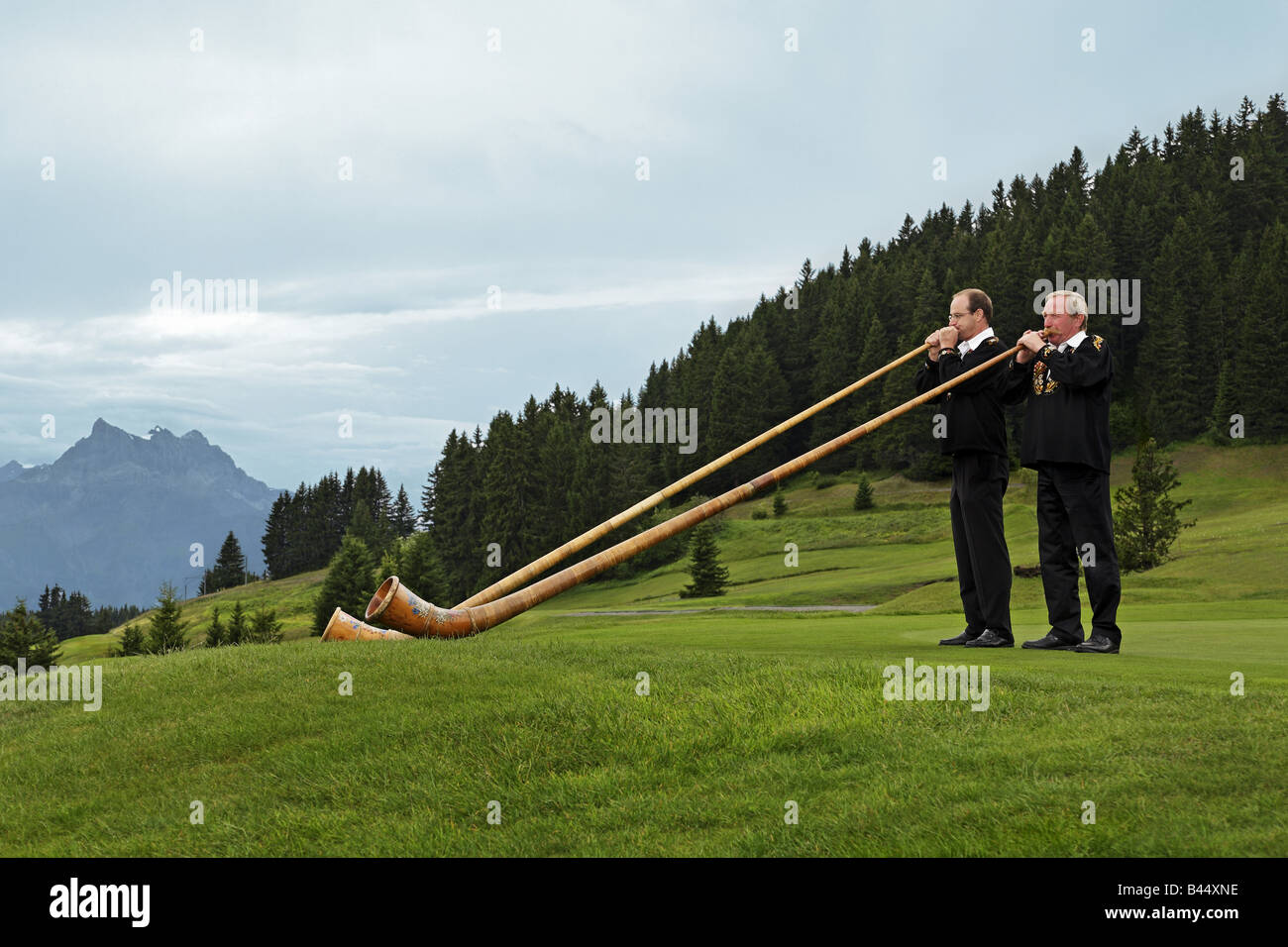 Alpine horn players in the mountain Stock Photo