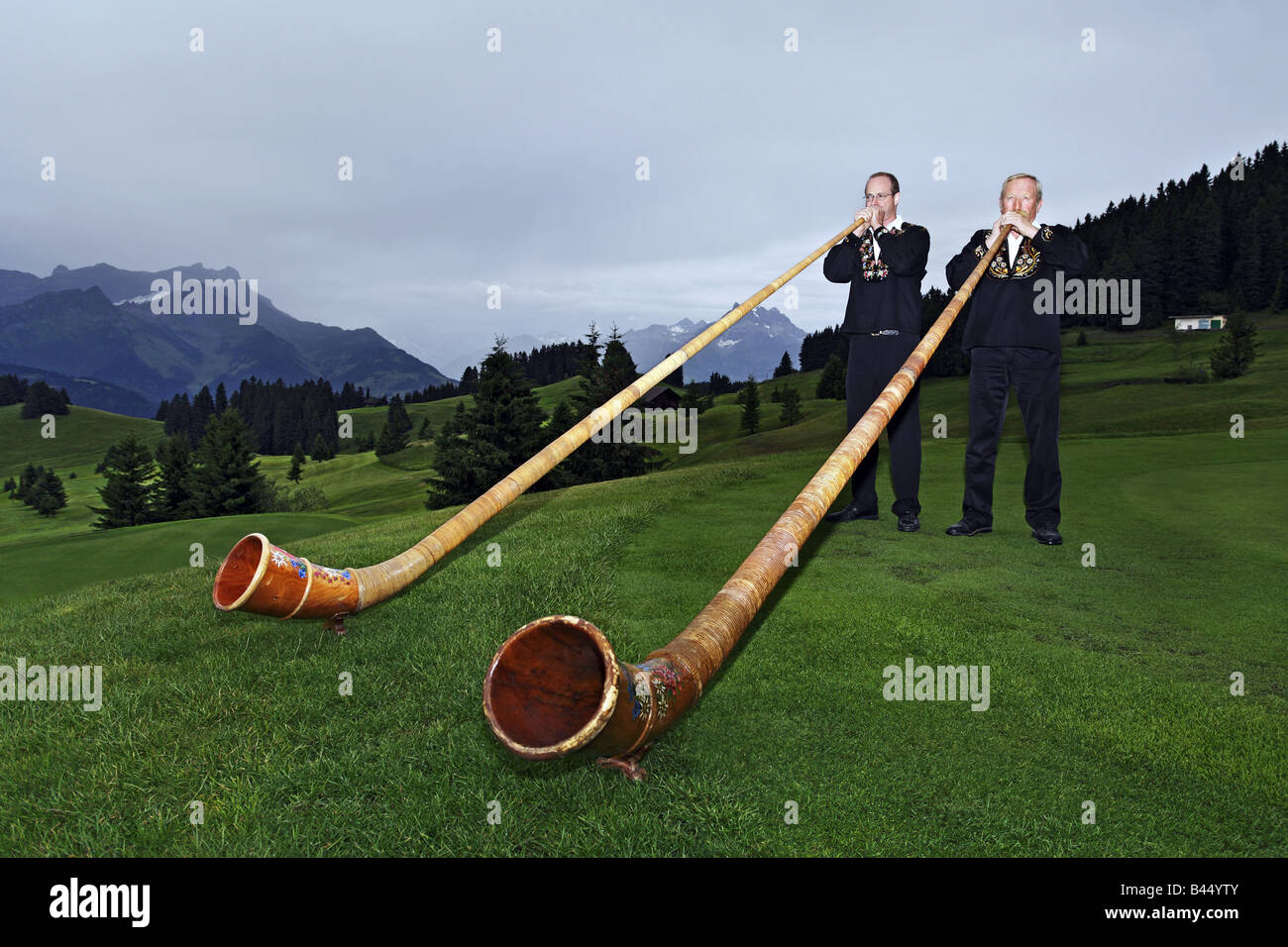 Alpine horn players in the mountain Stock Photo