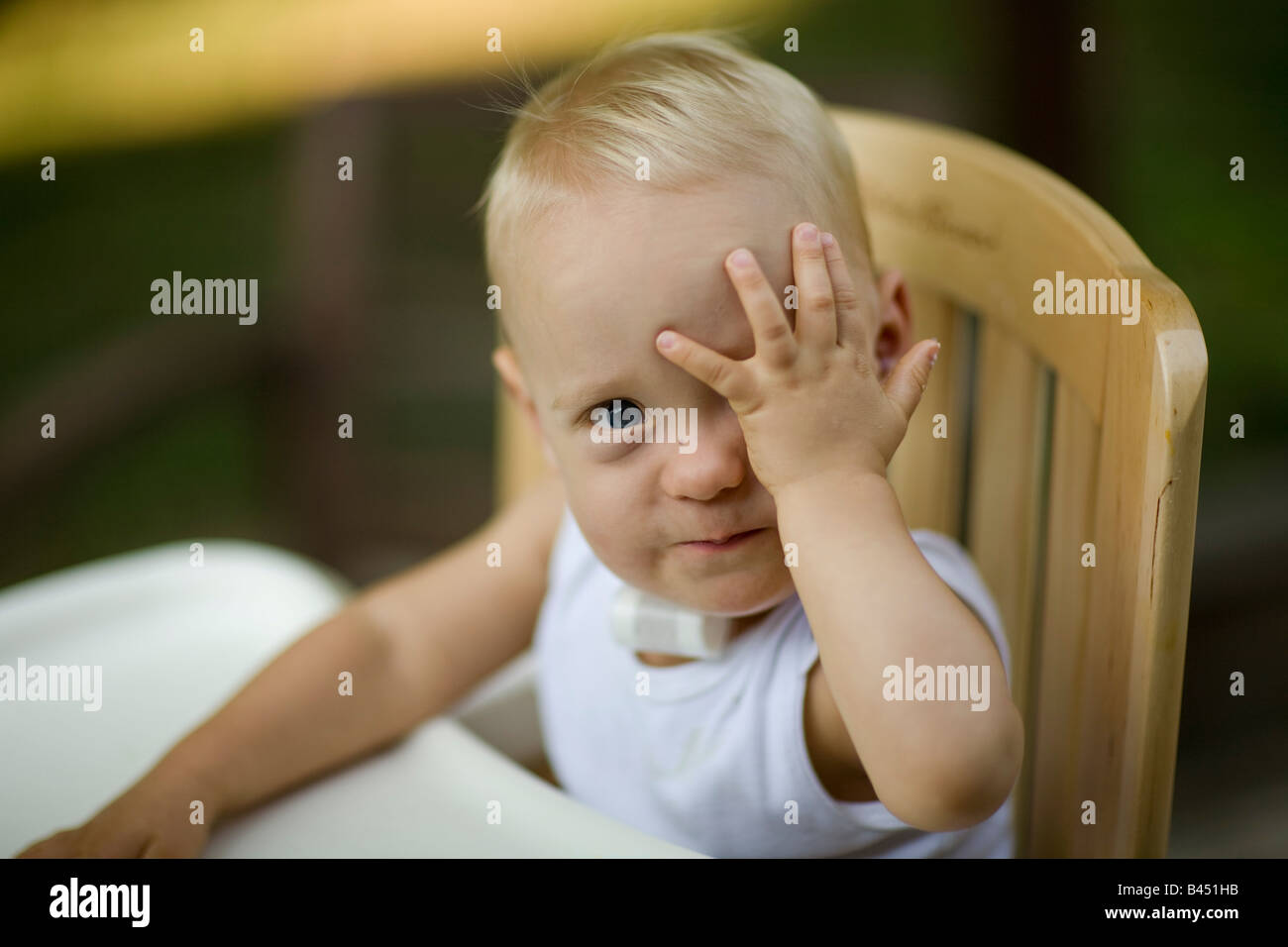 Young boy playing peek a boo Stock Photo