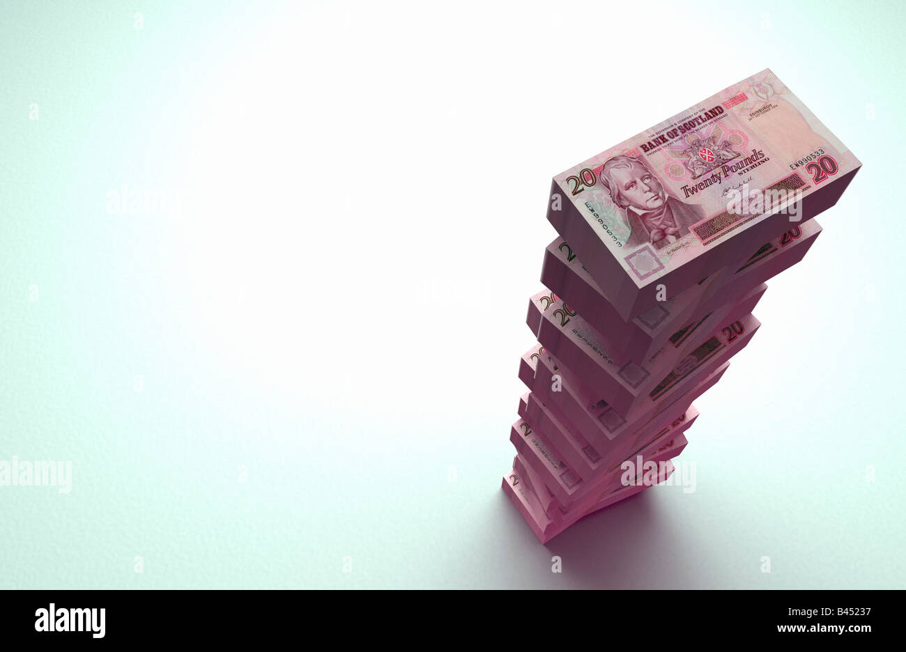 Large stack of £20 pound Scottish bank notes on plain background. Stock Photo