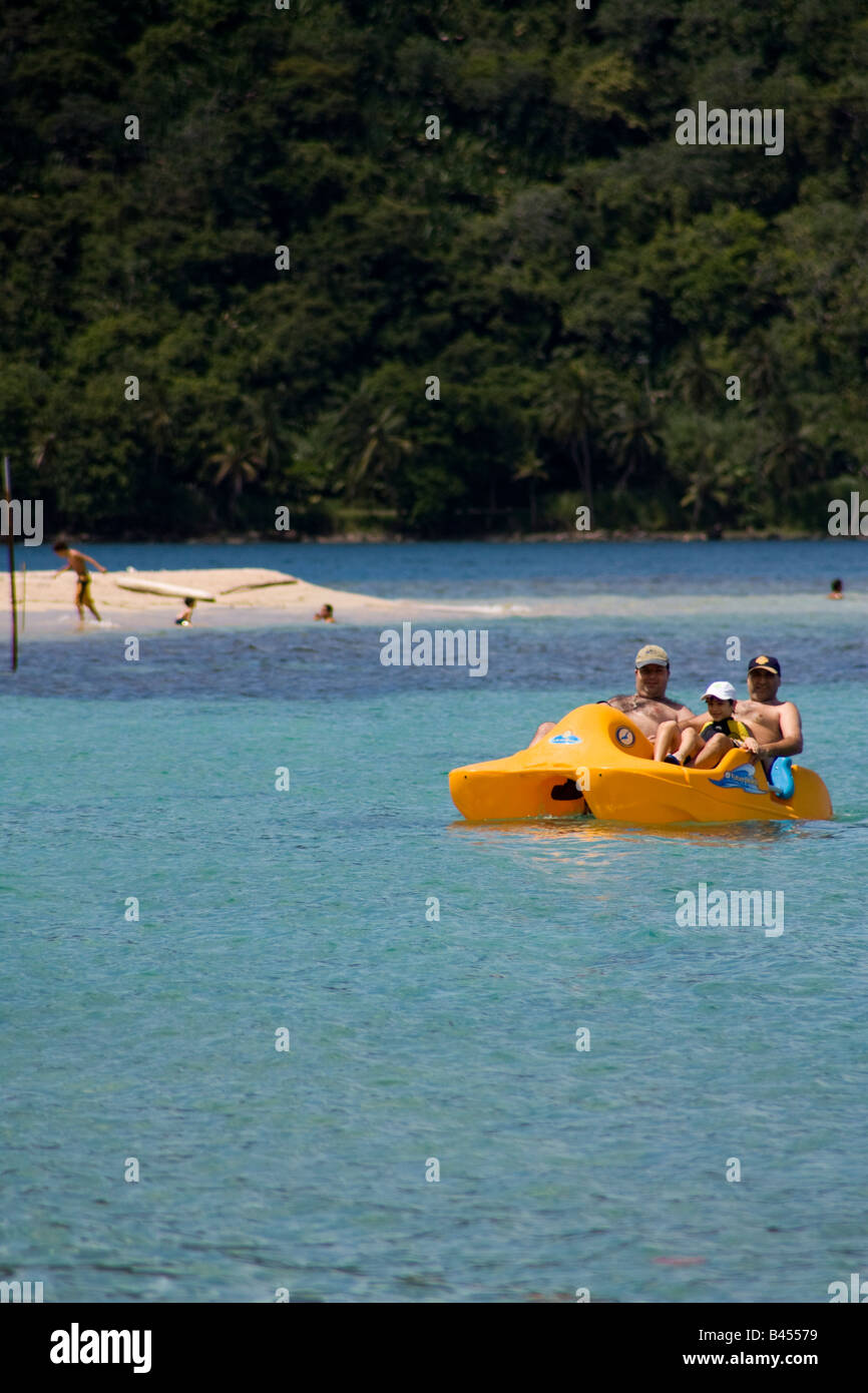 Panama, Isla Grande, Tourists enjoy a trip on the calm and crystalline Caribbean waters in a pedal boat Stock Photo