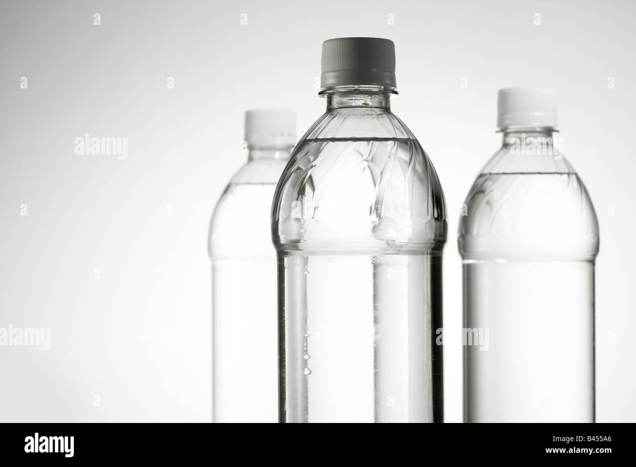 Three plastic water bottles h20 in studio white background horizontal Stock  Photo - Alamy